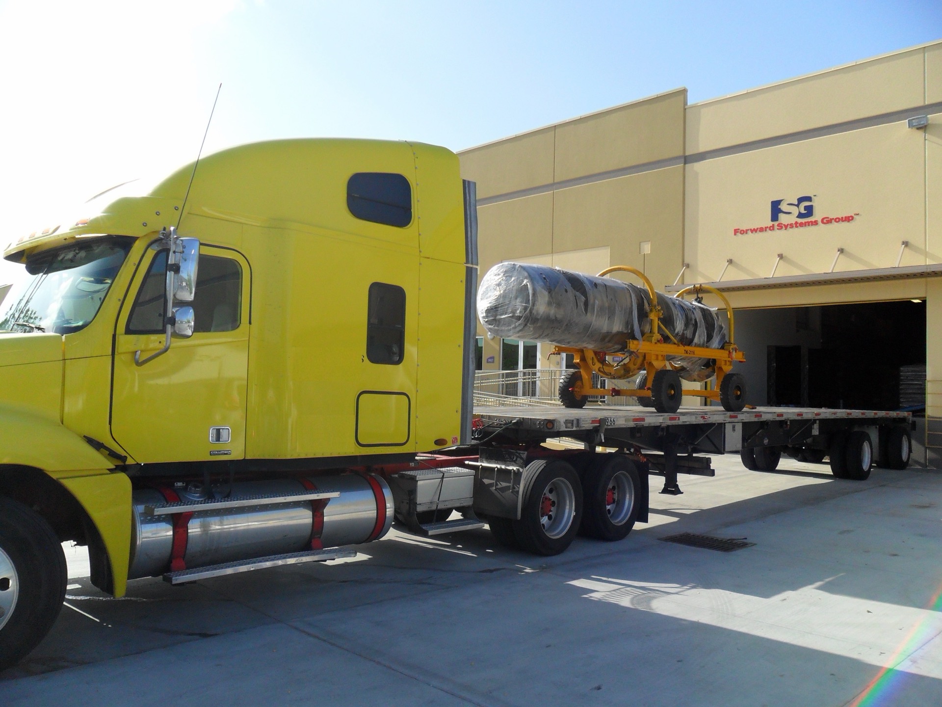 Forward Systems Group facility in Doral, Florida with defense cargo loaded on a flatbed at the dock